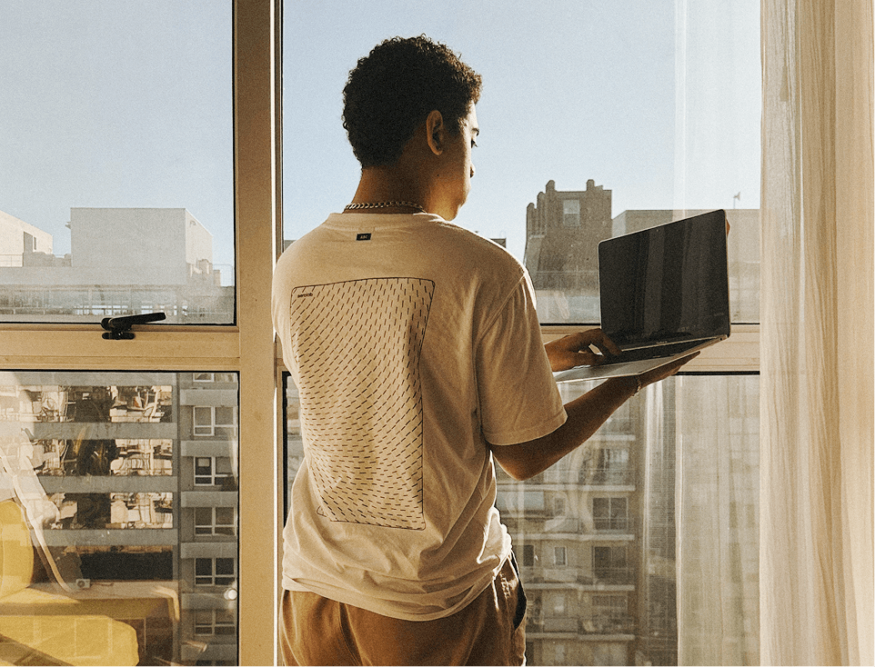 Person standing with a laptop 