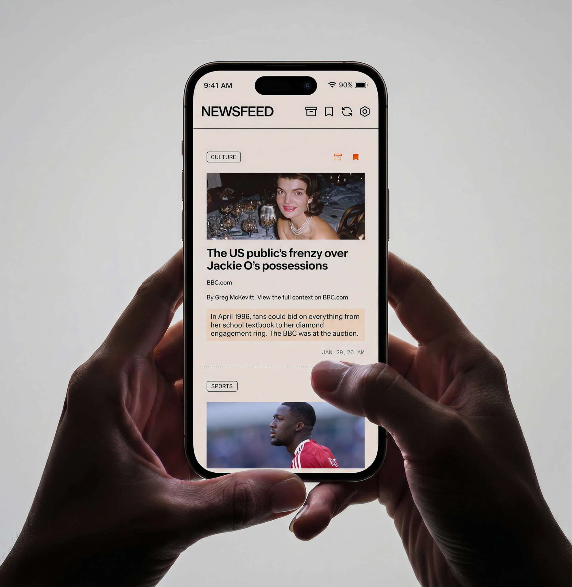 Hands holding a phone showing the Dreamer News/Feed app